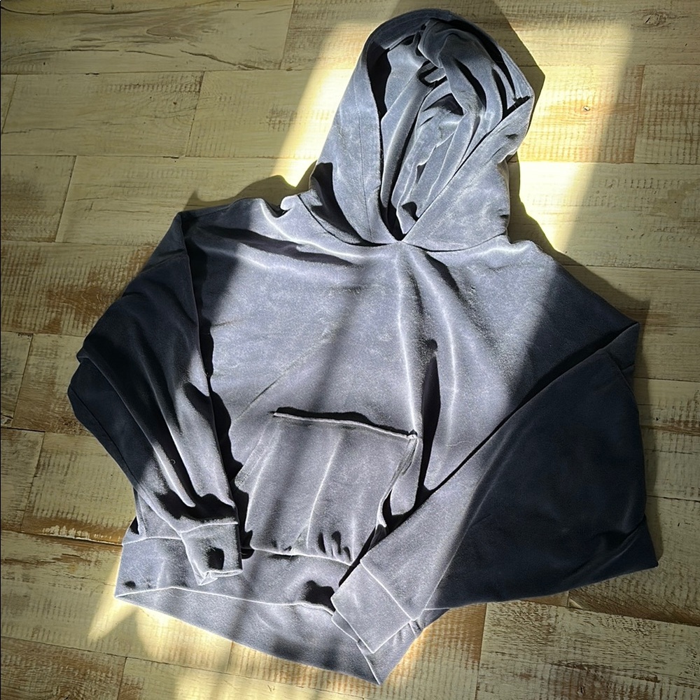 Woman’s soft grey pullover hoodie with pocket and hood